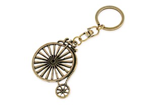 Oryginalny wzór w kształcie roweru - bicyklu w starym stylu, wykonany z metalu nieszlachetnego w kolorze złotym